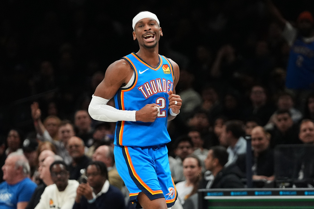 Oklahoma City Thunder's Shai Gilgeous-Alexander (2) celebrates after a teammate he passed the ball to hit a three-point shot during the second half of an NBA basketball game against the Brooklyn Nets Wednesday, March 18, 2026, in New York. (AP Photo/Frank Franklin II)