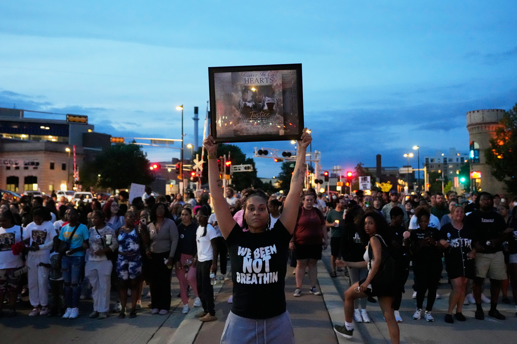 A protester holds a photo of Corey Durell Ruiz as they march Thursday, July 23, 2026, in Madison, Wis., after he was shot and killed by a Madison police officer on Wednesday. (AP Photo/Kayla Wolf)