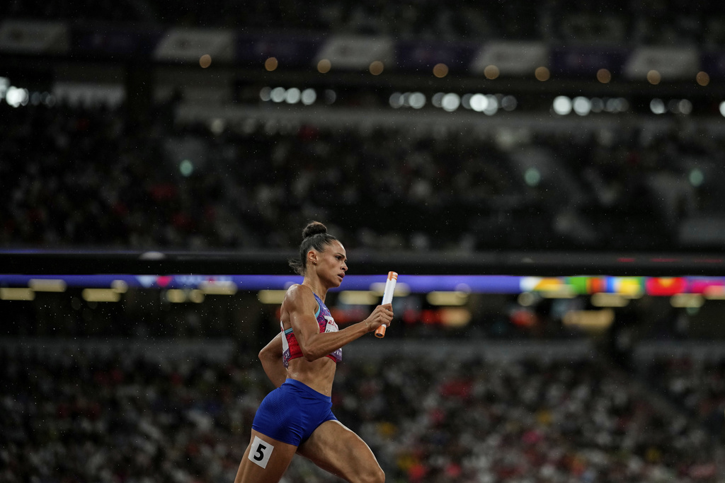 United States' Sydney McLaughlin-Levrone anchors her team to gold in the women's 4 X 400 meters relay at the World Athletics Championships in Tokyo, Sunday, Sept. 21, 2025. (AP Photo/Louise Delmotte)