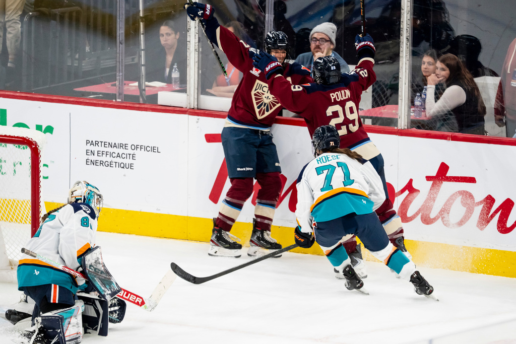 Montréal Victoire's Marie-Philip Poulin (29) celebrates her goal with teammate Laura Stacey (7) after scoring on New York Sirens goaltender Kayle Osborne (82) during second period PWHL hockey action in Tuesday, Nov. 25, 2025. (Christopher Katsarov/The Canadian Press via AP)