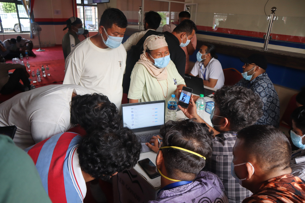 People inquire about the bodies of their relatives killed in flash floods at a mortuary in Chitwan, Nepal, Saturday, Aug. 29, 2026. (AP Photo/Nisha Shrestha)