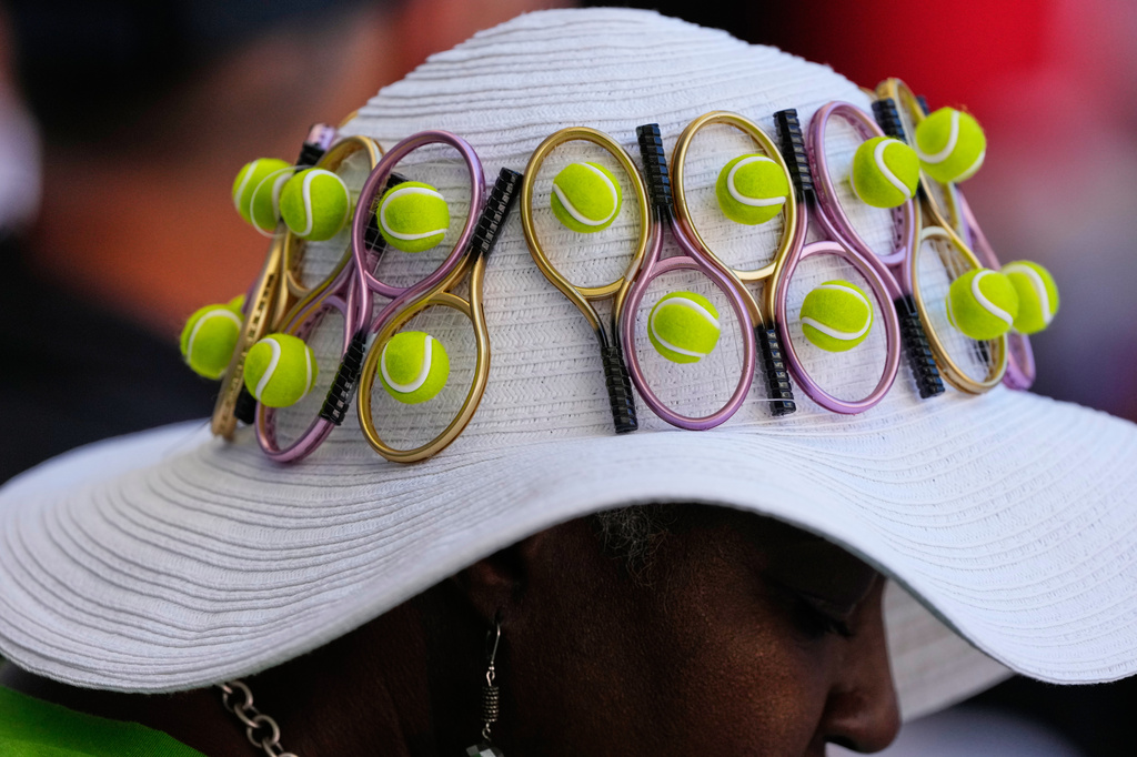 A person wears tennis-themed hat ahead of the men's singles semifinals of the U.S. Open tennis championships between Alexander Zverev, of Germany, and Karen Khachanov, of Russia, Friday, Sept. 11, 2026, in New York. (AP Photo/Seth Wenig)