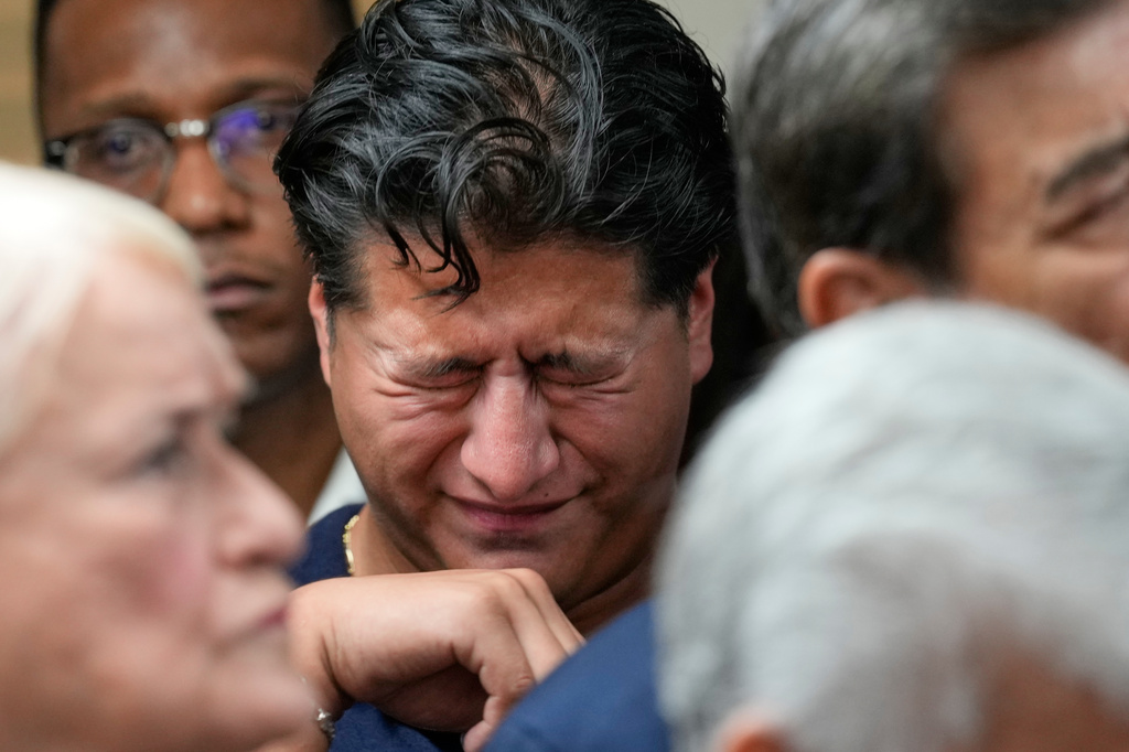 Ronaldo Salgado, son of Lorenzo Salgado Araujo, wipes away tears during a news conference Wednesday, July 8, 2026, in Houston. (AP Photo/David J. Phillip)