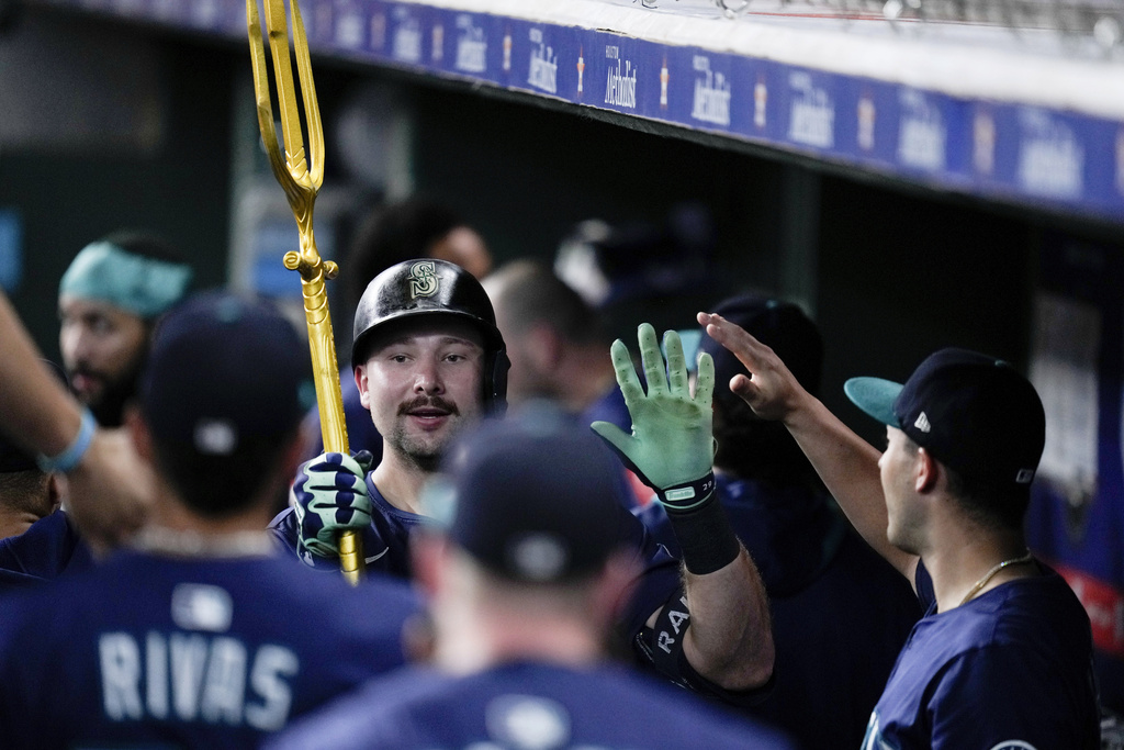 Seattle Mariners' Cal Raleigh carries a trident after hitting a solo home run, his 57th of the season, against the Houston Astros during the third inning of a baseball game Saturday, Sept. 20, 2025, in Houston. (AP Photo/Eric Christian Smith)