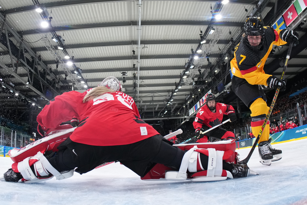 Germany's Franziska Feldmeier (7) scores her side's opening goal during a women's ice hockey quarterfinal game between Canada and Germany at the 2026 Winter Olympics, in Milan, Italy, Saturday, Feb. 14, 2026. (Sun Fei/Pool Photo via AP)