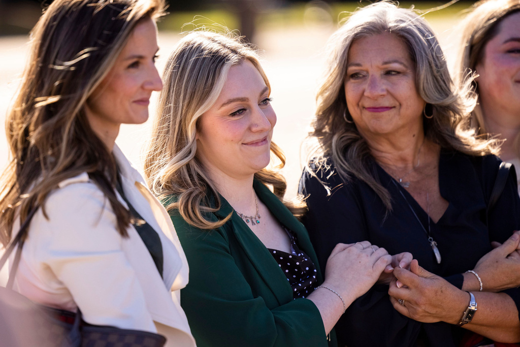 Abigail "Abby" Zwerner smiles with her mother Julie as her lawyers speak to members of the press after a verdict was reached in her lawsuit against the assistant principal, Ebony Parker, of Richneck Elementary School during proceedings at Newport News Circuit Court in Newport News, Va. on Thursday, Nov. 6, 2025. (Kendall Warner/The Virginian-Pilot via AP)