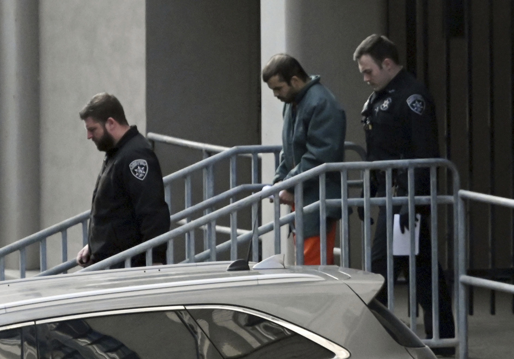 FILE - Mufid Fawaz Alkhader, center, is escorted out of the James T. Foley Courthouse following his court appearance, Friday, Dec. 8, 2023, in Albany, N.Y. (Will Waldron//The Albany Times Union via AP, file)