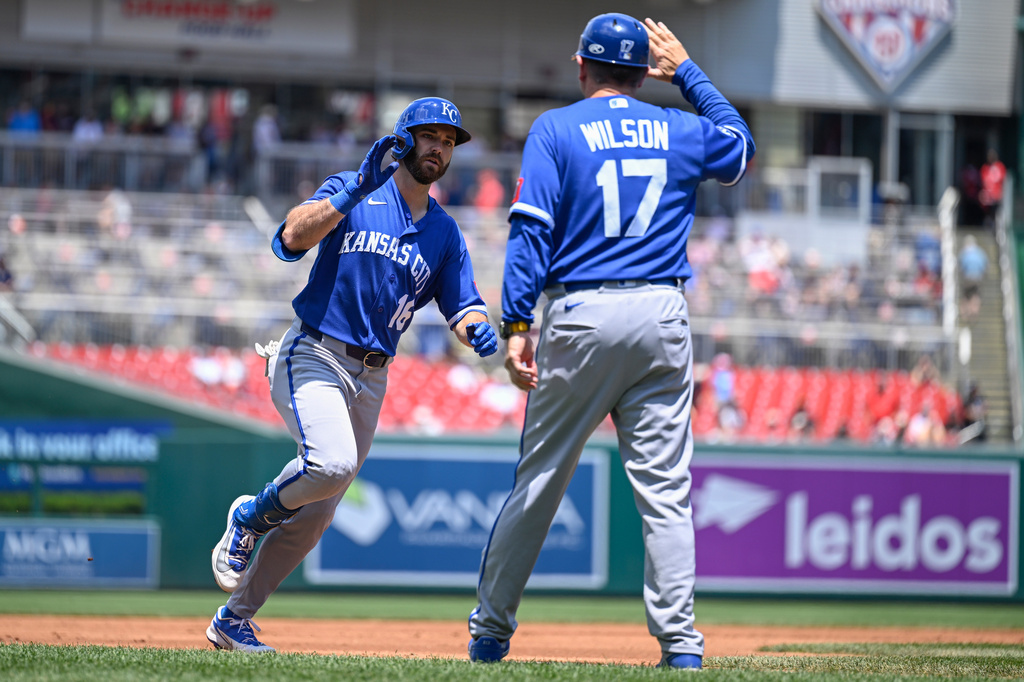 Kansas City Royals' John Rave is greeted by third base coach Vance Wilson after hitting a solo home run during the second inning of a baseball game against the Washington Nationals, Wednesday, June 17, 2026, in Washington. (AP Photo/John McDonnell)
