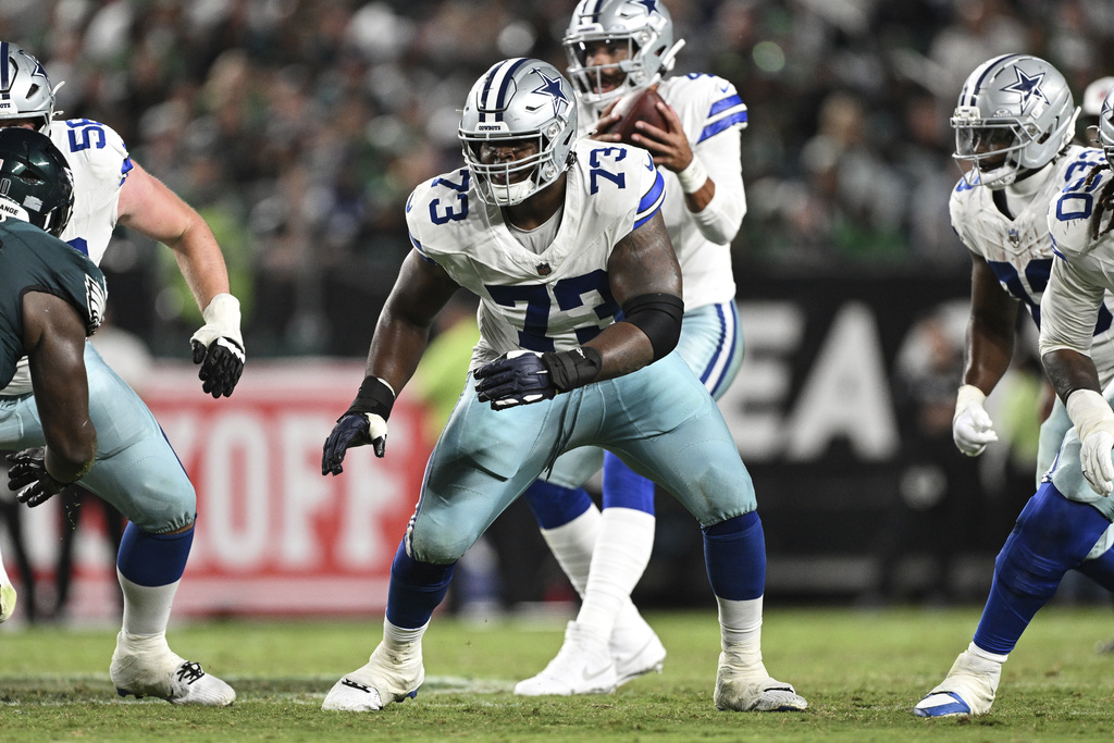 FILE - Dallas Cowboys guard Tyler Smith (73) prepares to block during the second half of an NFL football game against the Philadelphia Eagles, Thursday, Sept. 4, 2025, in Philadelphia. (AP Photo/Terrance Williams, File)