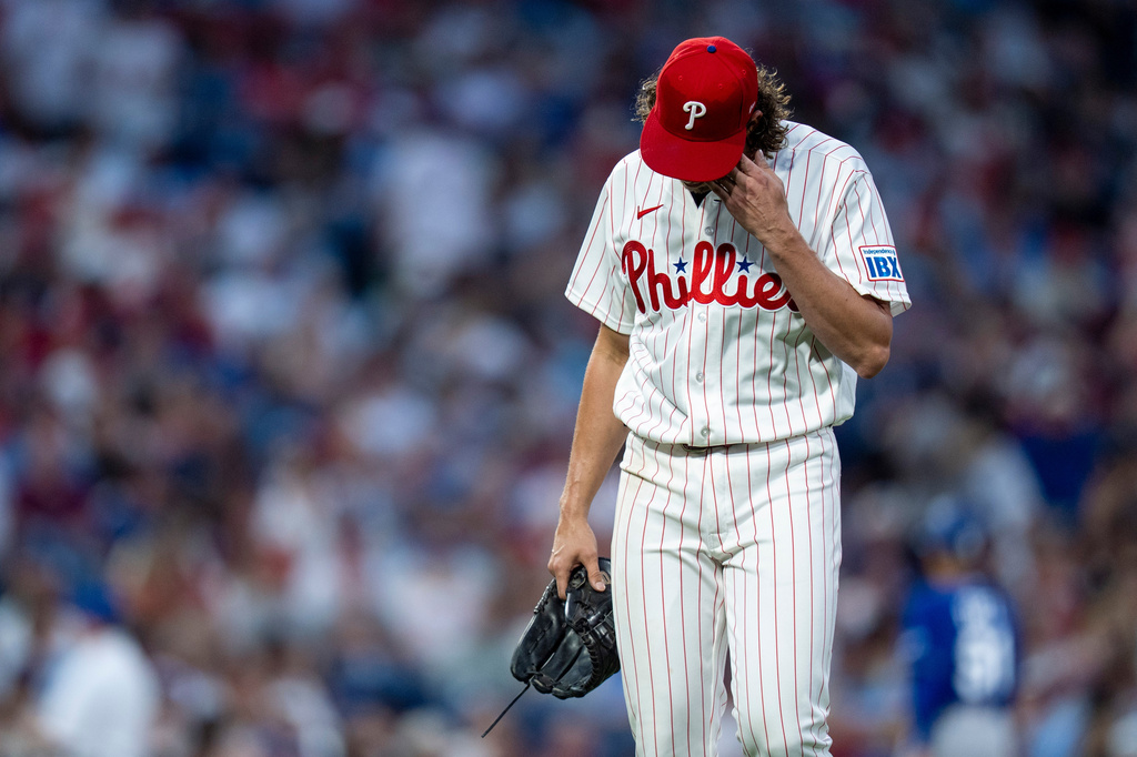 Philadelphia Phillies starting pitcher Aaron Nola heads to the dugout after getting pulled during the sixth inning of a baseball game against the Los Angeles Dodgers, Wednesday, July 22, 2026, in Philadelphia. (AP Photo/Chris Szagola)