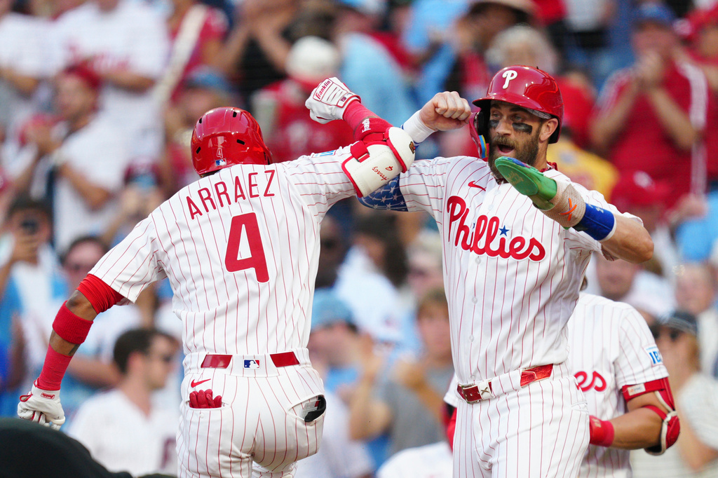 Philadelphia Phillies' Luis Arraez (4), celebrates his two-run home run with Bryce Harper hit off Miami Marlins pitcher Sandy Alcantara during the third inning of a baseball game, Wednesday, Aug. 19, 2026, in Philadelphia. (AP Photo/Derik Hamilton)