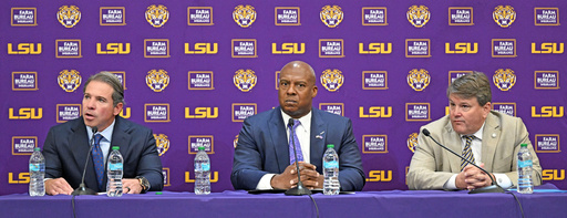 LSU board of supervisors member, from left, John H. Carmouche speaks alongside LSU interim athletic director Verge Ausberry and LSU board of supervisors chair Scott Ballard during a press conference to discuss the change in the LSU athletic department leadership, Friday, Oct. 31, 2025, in Baton Rouge, La. (Hilary Scheinuk/The Advocate via AP) LSU board of supervisors member, from left, John H. Carmouche speaks alongside LSU interim athletic director Verge Ausberry and LSU board of supervisors chair Scott Ballard during a press conference to discuss the change in the LSU athletic department leadership, Friday, Oct. 31, 2025, in Baton Rouge, La. (Hilary Scheinuk/The Advocate via AP)
