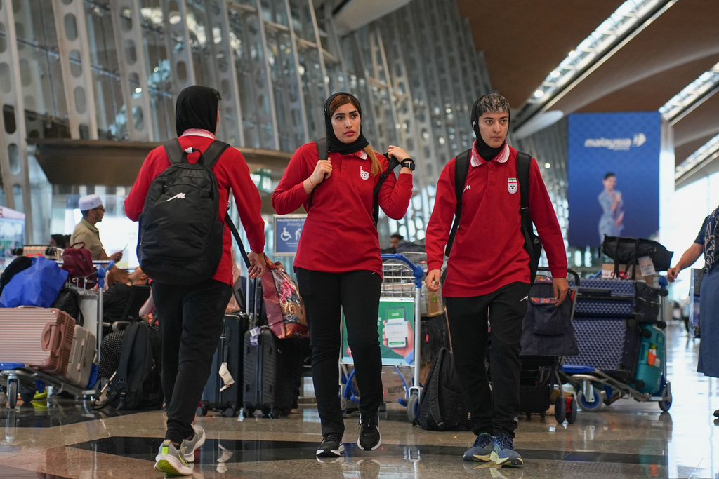 Members of Iran's women's football team arrive at the Kuala Lumpur International Airport in Sepang, Malaysia, Monday, March 16, 2026. (AP Photo/Azneal Ishak)
