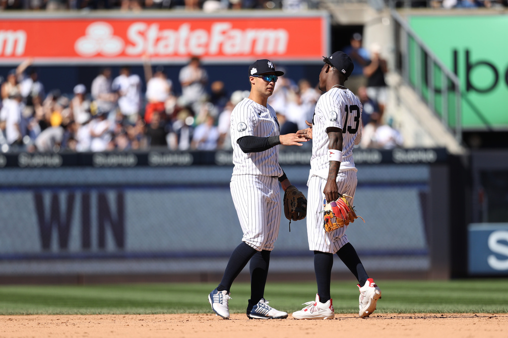 New York Yankees' Anthony Volpe, left, and Jazz Chisholm Jr. celebrate after defeating the Boston Red Sox during a baseball game, Sunday, June 7, 2026, in New York. (AP Photo/Pamela Smith)