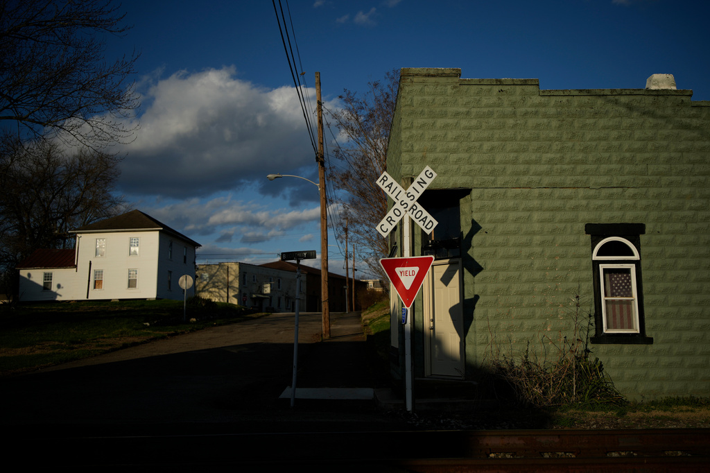 A railroad crossing is seen in the evening light, Thursday, March 12, 2026, in Ravenswood, W.Va., where some shop owners were forced to shut down during winter because they couldn't pay their electric bills. (AP Photo/Carolyn Kaster)