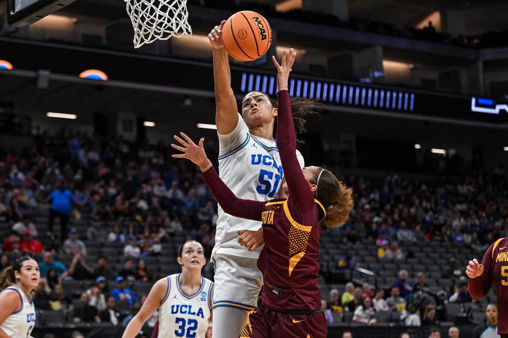 UCLA center Lauren Betts (51) blocks Minnesota guard Amaya Battle (3) during the first half in the Sweet 16 of the NCAA college basketball tournament Friday, March 27, 2026, in Sacramento, Calif. (AP Photo/Justine Willard)