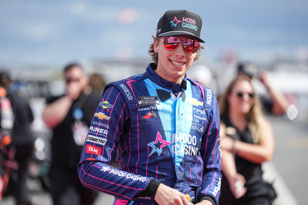 FILE - Carson Hocevar smiles prior to a NASCAR Cup Series auto race at Charlotte Motor Speedway, Oct. 5, 2025, in Concord, N.C. (AP Photo/Matt Kelley, File)