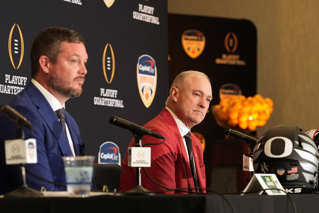 Texas Tech head coach Joey McGuire, right, and Oregon head coach Dan Lanning participate in a press conference ahead of the Orange Bowl College Football Playoff quarterfinal game, Wednesday, Dec. 31, 2025, in Dania Beach, Fla. (AP Photo/Rebecca Blackwell)