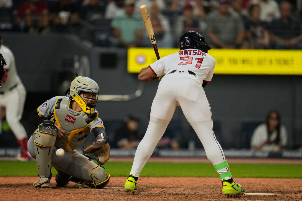 Pittsburgh Pirates catcher Rafael Flores Jr., left, reaches for a wild pitch thrown by pitcher Gregory Soto to Kahlil Watson, right, allowing Brayan Rocchio to score, in the eighth inning of the second baseball game of a split doubleheader in Cleveland, Saturday, June 18, 2026. (AP Photo/Sue Ogrocki)
