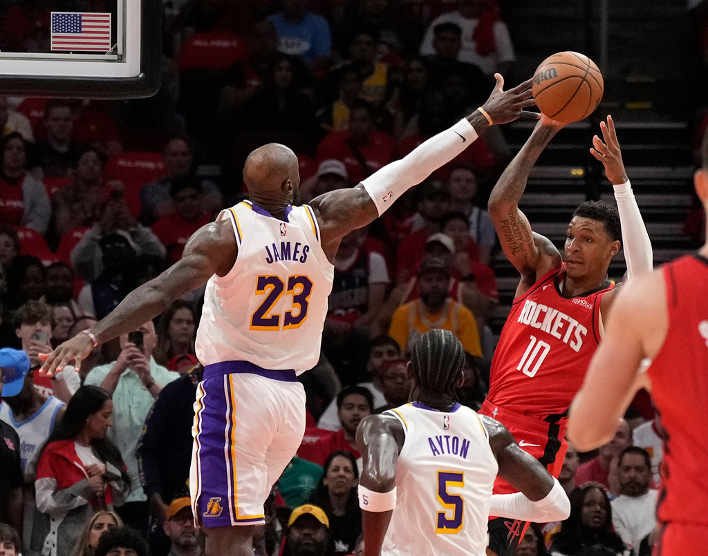 Houston Rockets forward Jabari Smith Jr. (10) looks to pass the ball against Los Angeles Lakers' LeBron James (23) and Deandre Ayton (5) during the first half in Game 4 of a first-round NBA basketball playoffs series, Sunday, April 26, 2026, in Houston. (AP Photo/Karen Warren)