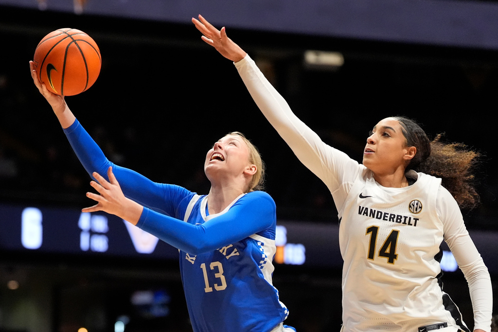 Kentucky center Clara Strack (13) shoots the ball past Vanderbilt forward Aiyana Mitchell (14) during the first half of an NCAA college basketball game Sunday, Feb. 22, 2026, in Nashville, Tenn. (AP Photo/George Walker IV)