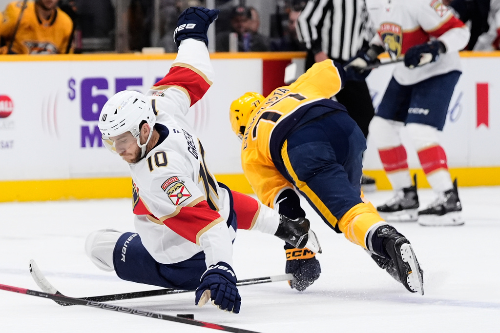 Florida Panthers left wing A.J. Greer (10) dives on a loose puck past Nashville Predators right wing Luke Evangelista (77) during the first period of an NHL hockey game Monday, Nov. 24, 2025, in Nashville, Tenn. (AP Photo/George Walker IV)