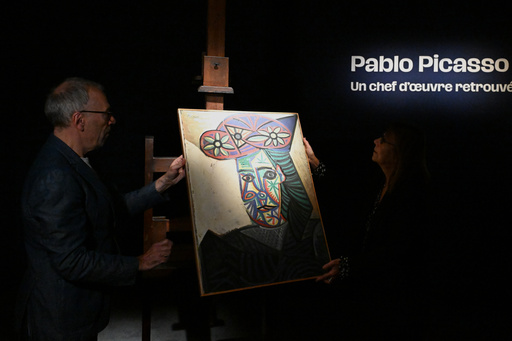 Art expert Agnes Sevestre-Barbe, right, and auction officer Christophe Lucien, stand by a rediscovered Picasso painting "Bust of a Woman in a Flowery Hat", Wednesday, Oct. 22, 2025 in Paris. The portrait painted in 1943 will be sold at auction Friday in Paris, was bought in 1944 and shows his partner Dora Maar. (AP Photo/Emma Da Silva) Art expert Agnes Sevestre-Barbe, right, and auction officer Christophe Lucien, stand by a rediscovered Picasso painting "Bust of a Woman in a Flowery Hat", Wednesday, Oct. 22, 2025 in Paris. The portrait painted in 1943 will be sold at auction Friday in Paris, was bought in 1944 and shows his partner Dora Maar. (AP Photo/Emma Da Silva)