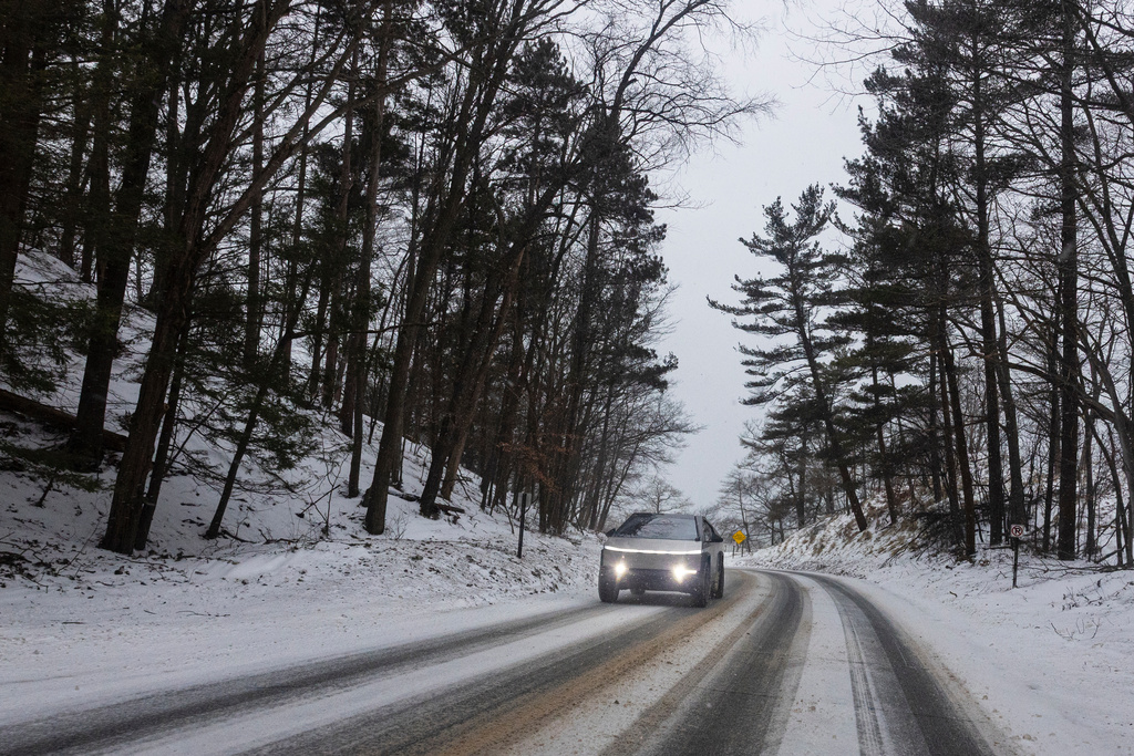 A Tesla Cyber truck is driven along North Scenic Drive through Muskegon State Park during a winter storm warning in Muskegon County, Mich. on Saturday, January 17, 2026. (Joel Bissell/Kalamazoo Gazette via AP)