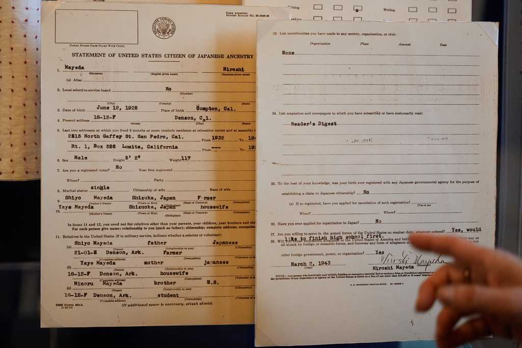 Rosalyn Tonai, Executive Director at the National Japanese American Historical Society, gestures toward a Hiroshi Mayeda's Statement of United States Citizen of Japanese Ancestry displayed in the "I am an American: The Nisei Soldier Experience" exhibit at the Military Intelligence Service Historic Learning Center in San Francisco, Wednesday, Feb. 25, 2026. (AP Photo/Jeff Chiu)