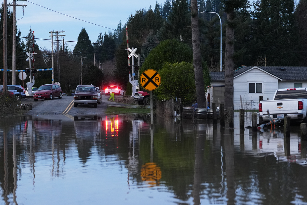 Floodwaters cover a road after heavy rains led to historic flooding in the region Saturday, Dec. 13, 2025, in Burlington, Wash. (AP Photo/Lindsey Wasson)