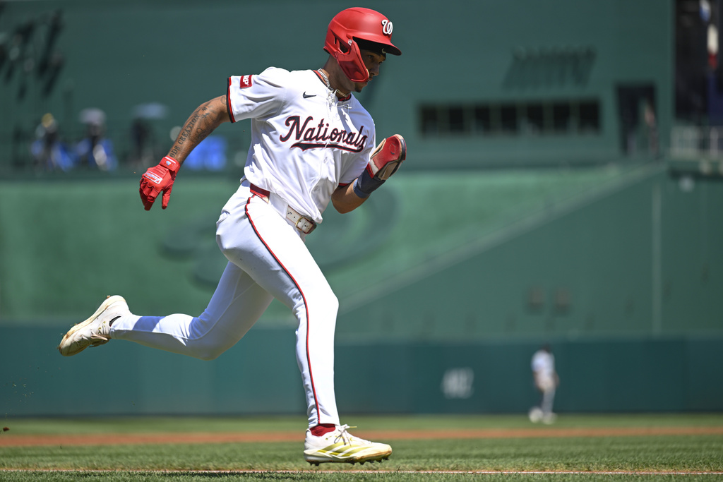Washington Nationals' Daylen Lile runs to home to score the second run on a two-run single by' Luis Garcia Jr. during the first inning of a baseball game against the Miami Marlins, Wednesday, Sept. 3, 2025, in Washington. (AP Photo/John McDonnell)