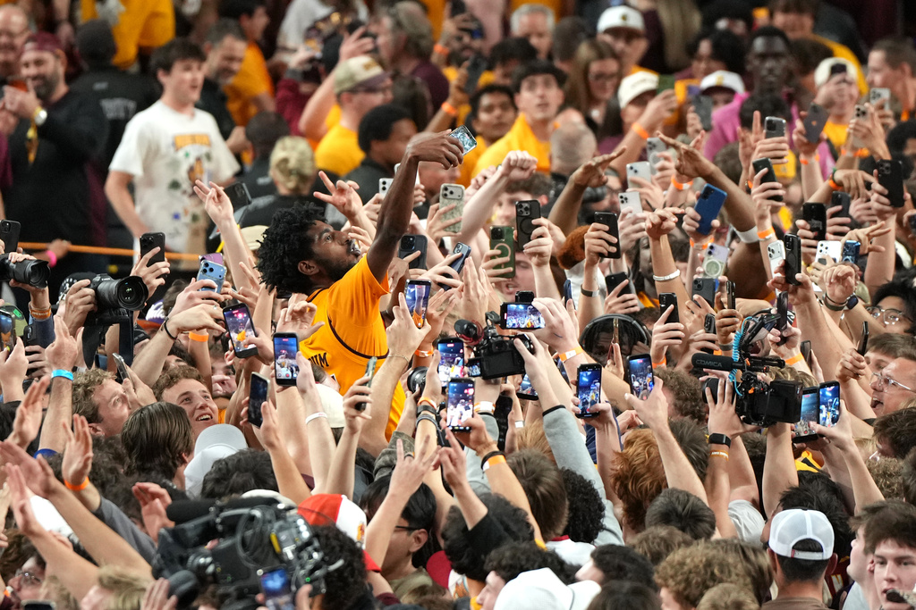 Arizona State guard Maurice Odum celebrates with fans after defeating Kansas during an NCAA college basketball game, Tuesday, March 3, 2026, in Tempe, Ariz. (AP Photo/Rick Scuteri)