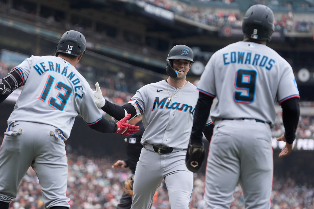 Miami Marlins' Graham Pauley, middle, is congratulated by Heriberto Hernández (13) after hitting a three-run home run that also scored Xavier Edwards (9) and Liam Hicks during the second inning of a baseball game against the San Francisco Giants Sunday, April 26, 2026, in San Francisco. (AP Photo/Jeff Chiu)
