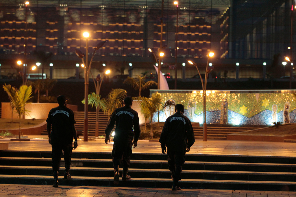 FILE - Local security agents walk through a plaza in Sipopo, a luxury complex constructed to host the upcoming 17th African Union Summit, outside Malabo, Equatorial Guinea, June 28, 2011. (AP Photo/Rebecca Blackwell, File)