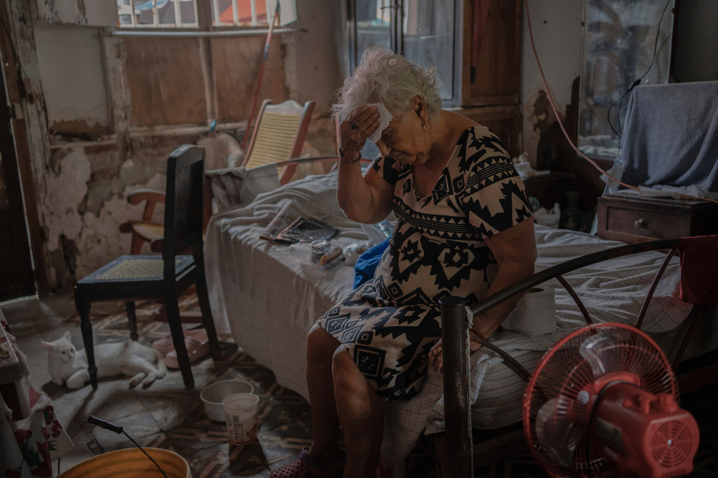 FILE - Margarita Salazar, 82, wipes the sweat off with a tissue inside her home amid hot weather in Veracruz, Mexico, on June 16, 2024. (AP Photo/Felix Marquez, File)
