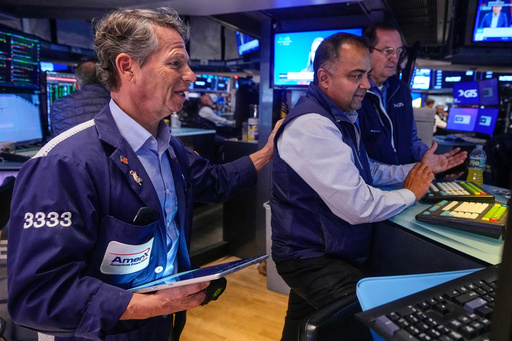 Trader Robert Charmak, left, and specialist Dilip Patel, center, work on the floor of the New York Stock Exchange, Monday, Oct. 13, 2025. (AP Photo/Richard Drew) Trader Robert Charmak, left, and specialist Dilip Patel, center, work on the floor of the New York Stock Exchange, Monday, Oct. 13, 2025. (AP Photo/Richard Drew)