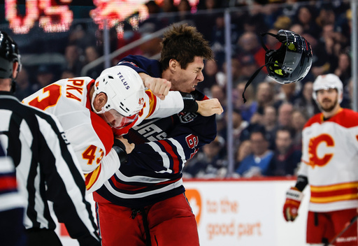 Winnipeg Jets' Logan Stanley (right) and Calgary Flames' Adam Klapka (43) fight during first period NHL action in Winnipeg on Friday, Oct. 24, 2025. (John Woods/The Canadian Press via AP) Winnipeg Jets' Logan Stanley (right) and Calgary Flames' Adam Klapka (43) fight during first period NHL action in Winnipeg on Friday, Oct. 24, 2025. (John Woods/The Canadian Press via AP)