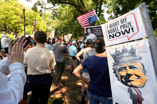 FILE - Activists carry signs during a protest against President Donald Trump's federal takeover of policing of the District of Columbia, Saturday, Aug. 16, 2025, in Washington. (AP Photo/Alex Brandon, File) FILE - Activists carry signs during a protest against President Donald Trump's federal takeover of policing of the District of Columbia, Saturday, Aug. 16, 2025, in Washington. (AP Photo/Alex Brandon, File)
