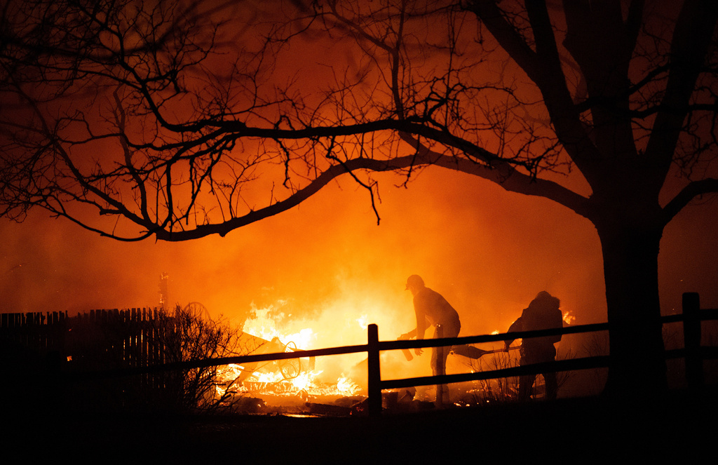 FILE - Residents fight the Marshall Fire in Louisville, Colo., Dec. 30, 2021. (Christian Murdock/The Gazette via AP, File)
