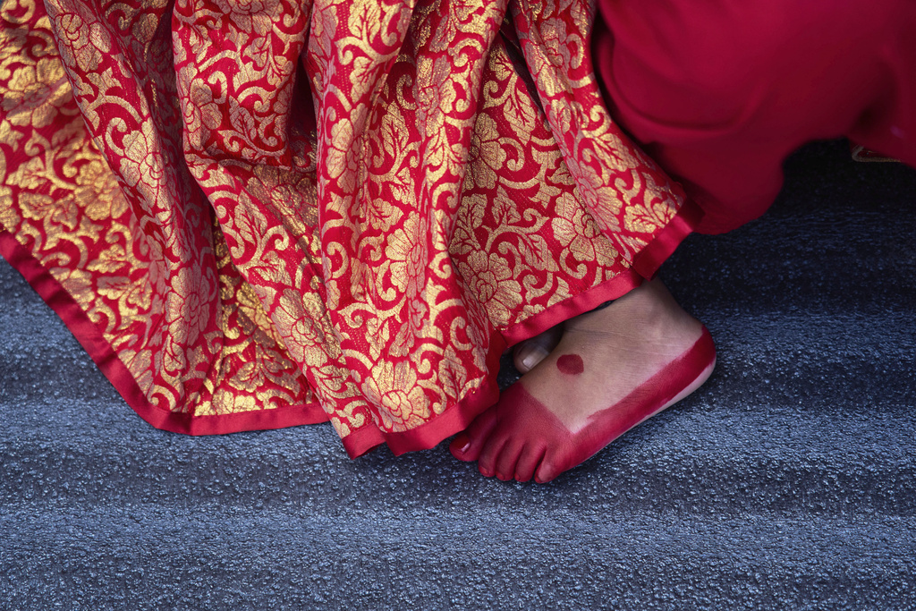 A young Newar girl, dressed to represent divine female energy, waits for Kumari Puja, a ritual during which she will be worshipped at Hanuman Dhoka, Basantapur Durbar Square, Kathmandu, Nepal, Friday, Sept. 5, 2025. (AP Photo/Niranjan Shrestha)