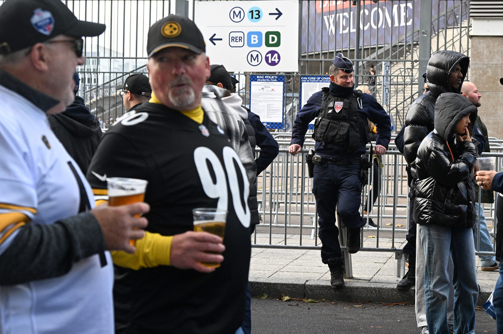 A police officer stands outside the Stade de France stadium before the start of the NFL football game between Pittsburgh Steelers and New Orleans Saints in Saint-Denis, outside Paris, Sunday, Oct. 25, 2026. (AP Photo/Emma Da Silva)