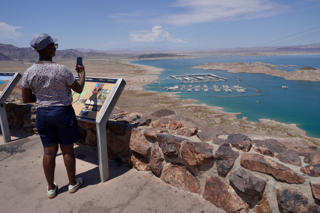 A tourist takes a photo of Lake Mead near Boulder City, Nev., on Friday, Aug. 7, 2026. (AP Photo/Ty ONeil)