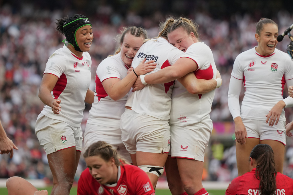 England's Alex Matthews, third left, celebrates with her teammates after scoring a try during the Women's Rugby World Cup final match between England and Canada at the Allianz Stadium, Twickenham, London, Saturday, Sept. 27, 2025. (AP Photo/Alastair Grant)