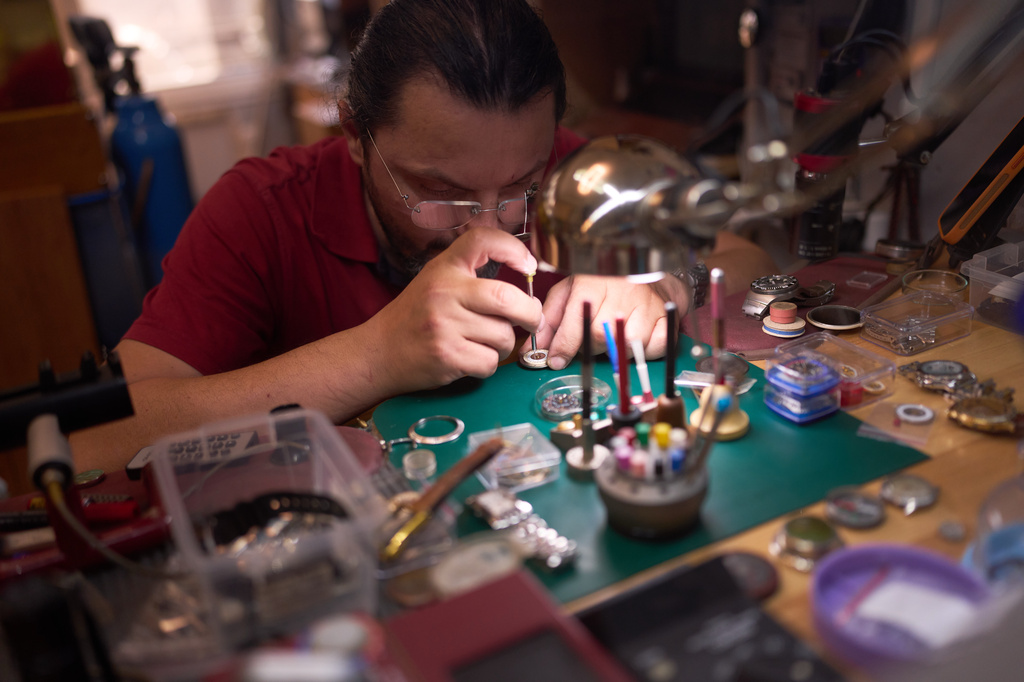 Watch and clock repairer Kenan Kaya works in his workshop in Istanbul's Sirkeci commercial district, Wednesday, Aug. 5, 2026. (AP Photo/Francisco Seco)