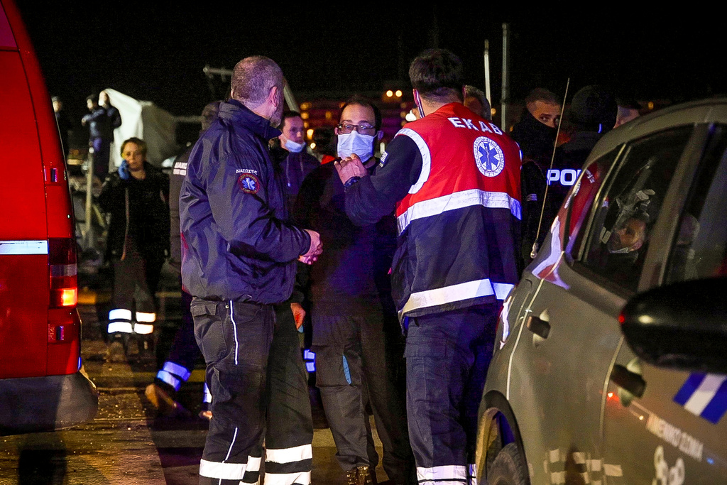 Rescue workers and paramedics wait at the port on the eastern Aegean island of Chios, Greece, late Tuesday, Feb. 3, 2026, after a collision between a migrant speedboat and a coast guard patrol vessel killed multiple people. (Kostas Anagnostou/Eurokinissi via AP)