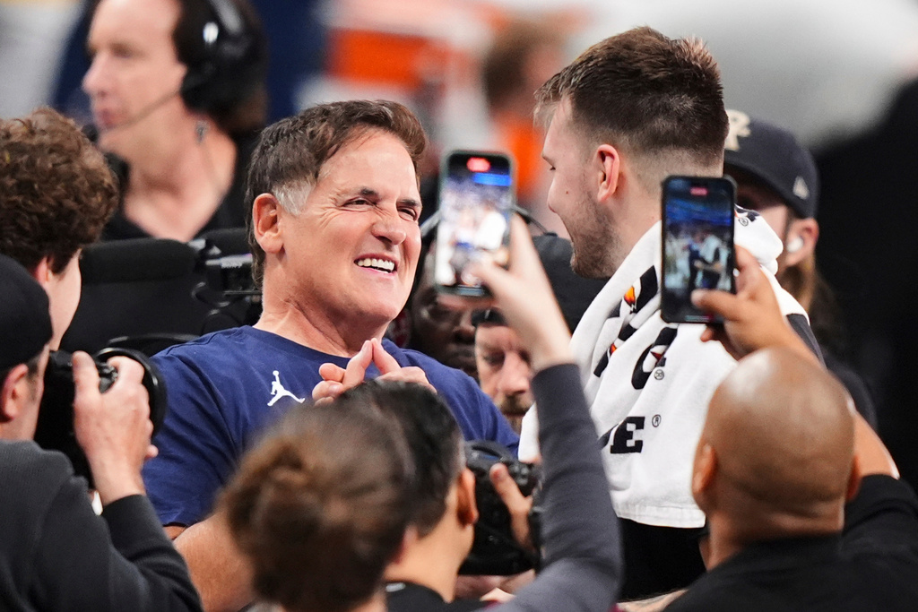 FILE - Mark Cuban, center left, greets former Dallas Mavericks player Luka Doncic of the Los Angeles Lakers following an NBA basketball game in Dallas, April 9, 2025. (AP Photo/LM Otero, File)