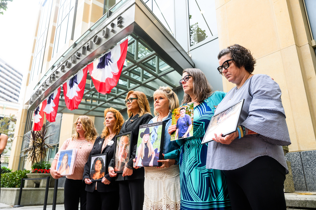 Parents hold pictures of their deceased children during a protest against social media platforms outside the Ronald V. Dellums Federal Building and U.S. Courthouse on Tuesday, Aug. 18, 2026, in Oakland, Calif. (AP Photo/Noah Berger)