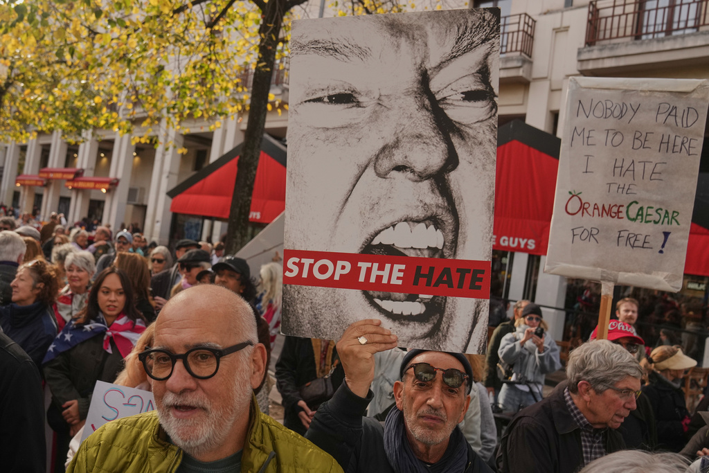 People attend a protest against U.S. President Donald Trump, in Paris, Saturday, Oct. 18, 2025. (AP Photo/Thibault Camus)