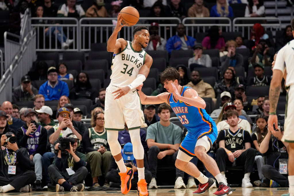 Milwaukee Bucks forward Giannis Antetokounmpo (34) passes the ball against Oklahoma City Thunder guard Brooks Barnhizer (23) during the second half of a preseason NBA basketball game Tuesday, Oct. 14, 2025, in Milwaukee. (AP Photo/Kayla Wolf)