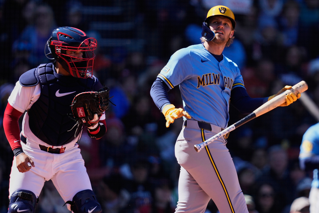 Milwaukee Brewers' Jake Bauers, right, strikes out with two on to end the top of the third inning as Boston Red Sox catcher Carlos Narváez, left, starts to head back to the dugout during a baseball game at Fenway Park, Wednesday, April 8, 2026, in Boston. (AP Photo/Charles Krupa)